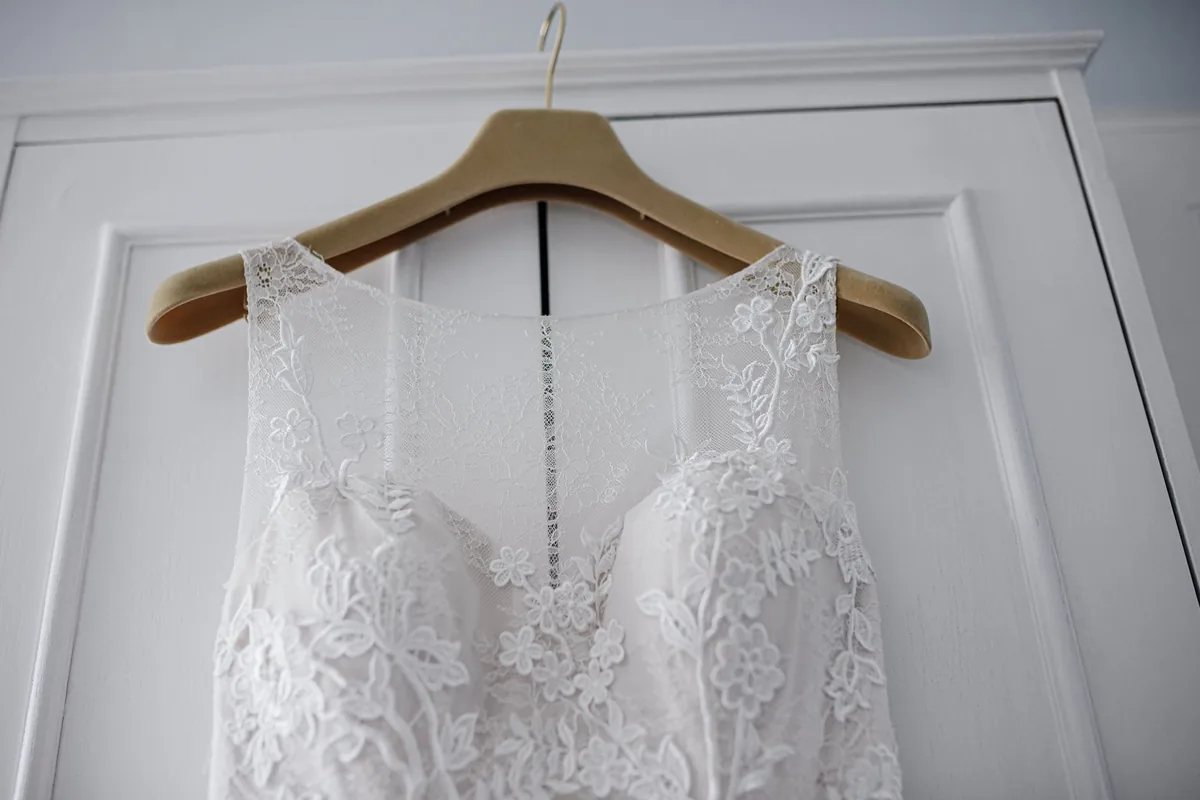 Budget the dress and its alterations together, and photograph it in real light.