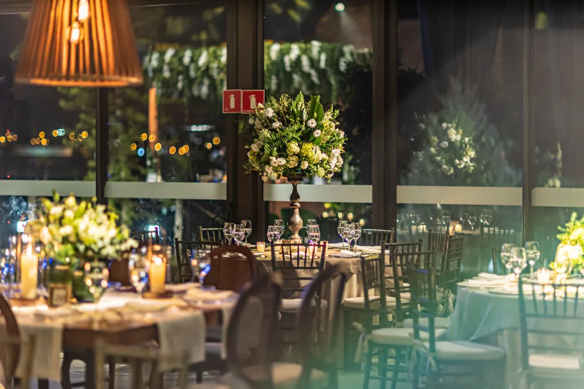 Reuse ceremony arrangements at the reception: design them to be lifted, not rebuilt.